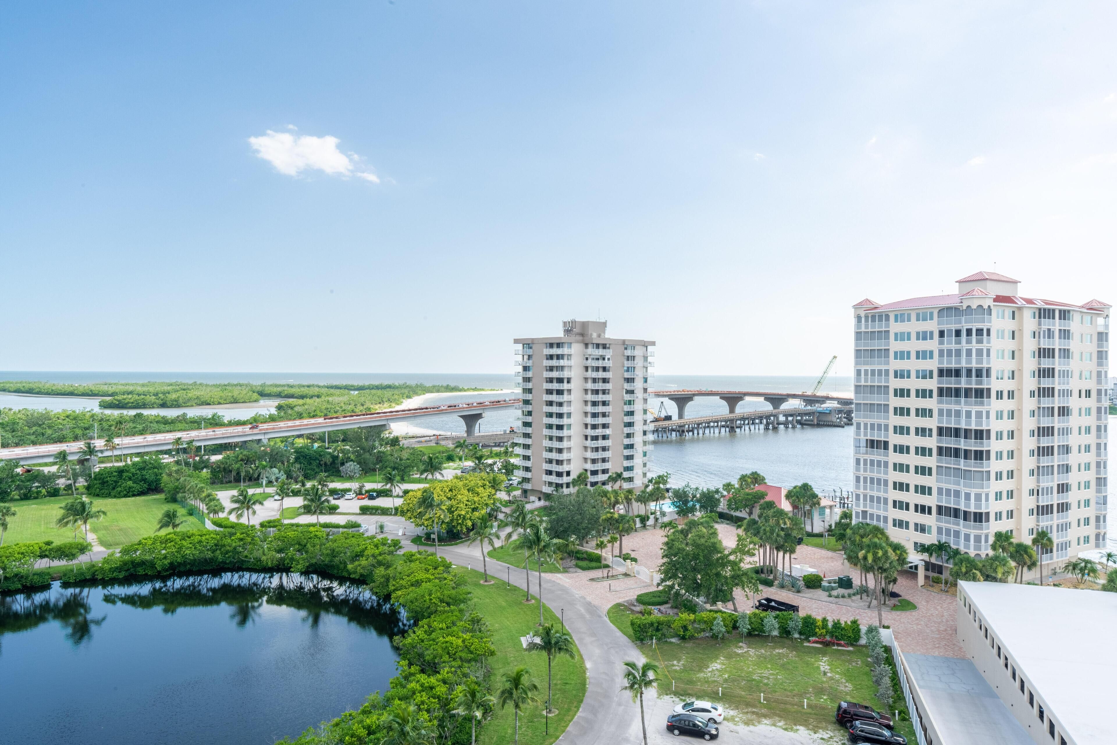 A high-rise hotel with a view of a bridge and water.