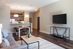 Apartment, 1 Bedroom | Living area | 50-inch TV with digital channels