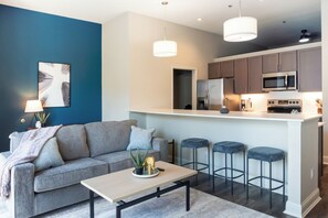 Apartment, 2 Bedrooms | Living area | 50-inch TV with digital channels