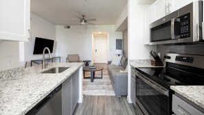 Studio | Privékeuken | Een koelkast met diepvriezer, een microgolfoven, een oven, een kookplaat