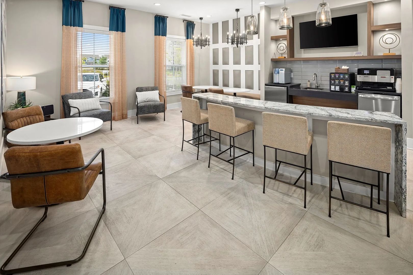 A modern kitchen with a marble countertop, bar stools, and a built-in oven.