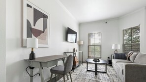 Apartment, 1 Bedroom | Living area | 50-inch TV with digital channels