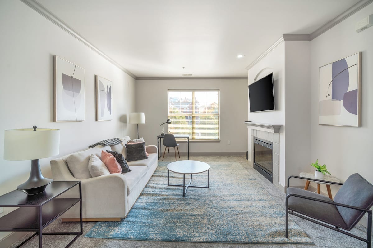 A modern living room with a sofa, coffee table, and TV.