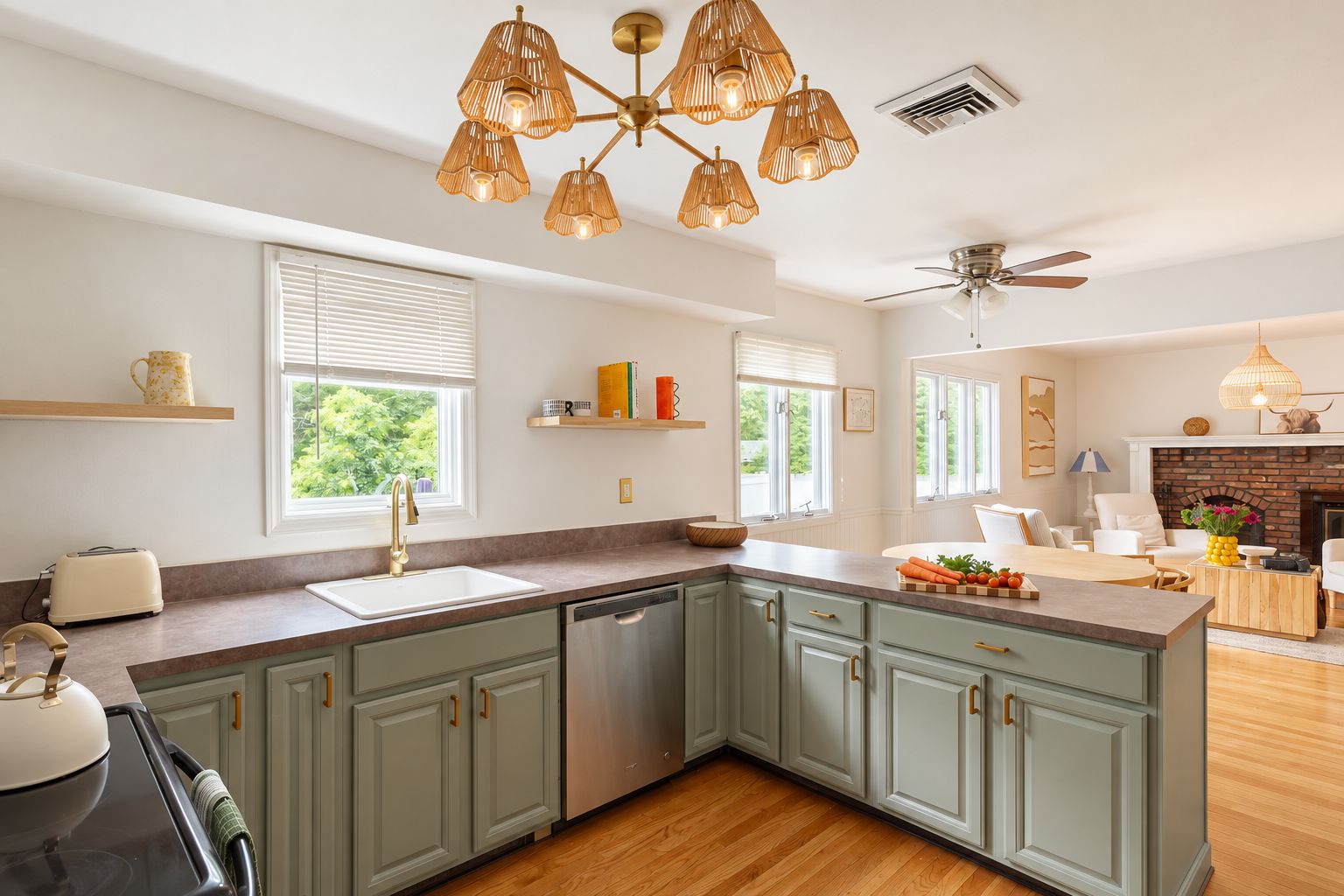 A modern kitchen with a central island, built-in appliances, and a dining area with a fireplace.