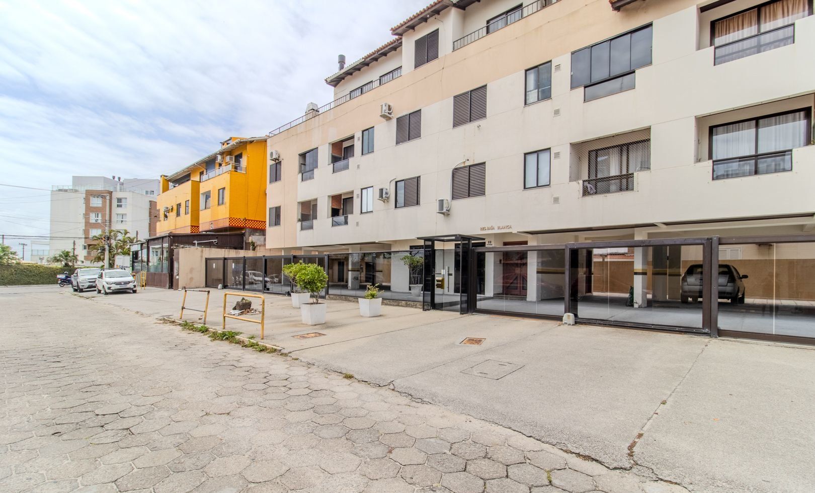 A multi-story building with a ground-level commercial space and upper residential units.