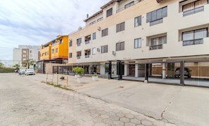 A multi-story building with a ground-level commercial space and upper residential units.