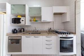 A compact kitchen with a dishwasher, microwave, stove, and oven. - Apt With Pool 250m From Jurere Beach Aya201 (Florianópolis)