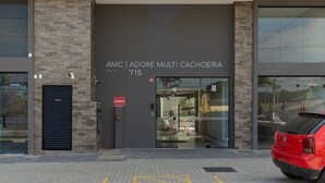 A modern building with a sign reading "AMC | ADORE MULTI CACHOEIRA 715". - Modern Apartment Near the Beach! - Atc0301 (Florianópolis)