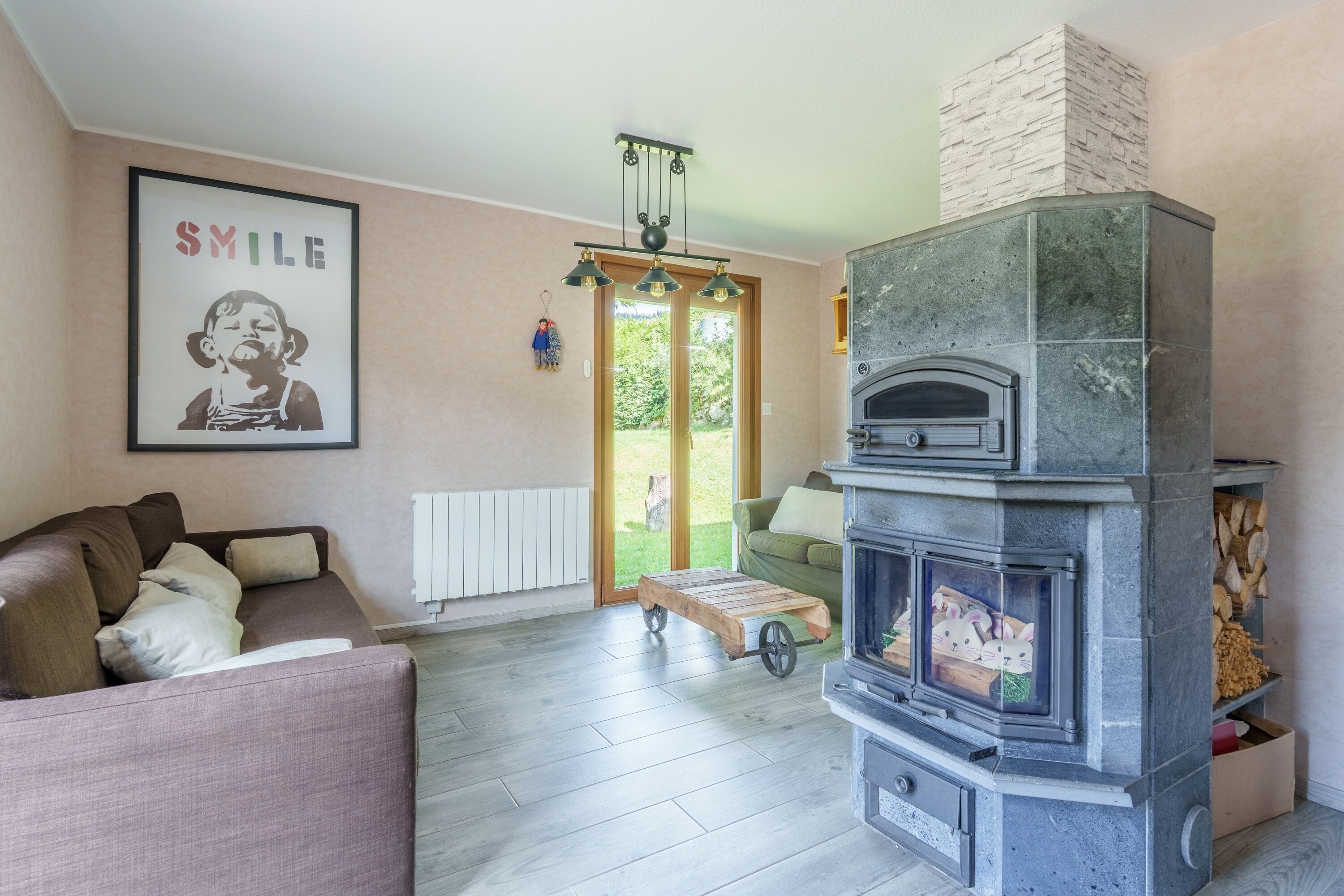 A living room with a fireplace, a sofa, a coffee table, and a framed picture on the wall.