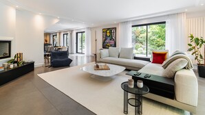 Un salon moderne avec un canapé, une table basse et un téléviseur.