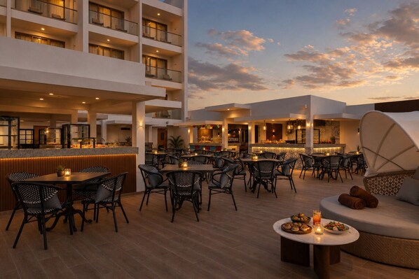 Restaurante no terraço com área externa, bar e vista do céu.
