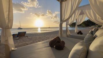 On the beach, beach cabanas, beach umbrellas, beach towels