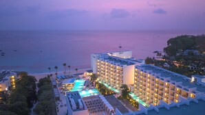 A hotel with a pool, beach view, and multiple balconies. - Royalton Vessence Barbados Adult-Oriented, an Autograph Collection All-Inclusive Resort – Now Open (Holetown)