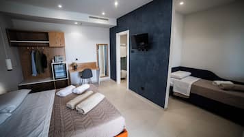 Luxe driepersoonskamer, uitzicht op zwembad | Een minibar, een kluis op de kamer, een bureau, verduisterende gordijnen