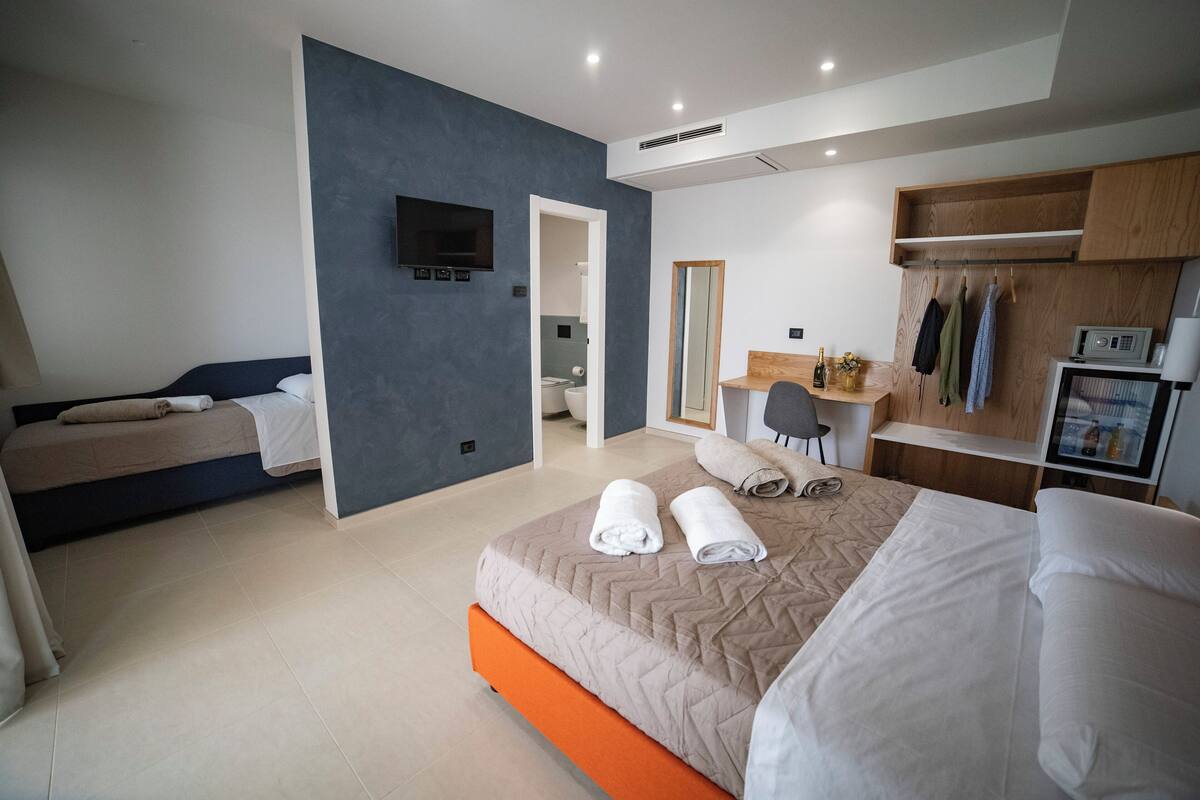 Superior Triple Room, Pool View | Minibar, in-room safe, desk, blackout drapes