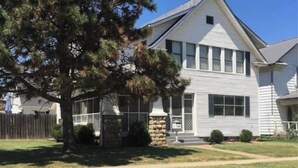 A two-story house with a gabled roof, a front porch, and a large tree in the yard. - -Beautiful 4.5 BR / 4 Ba home with 2 car garage (Cushing)