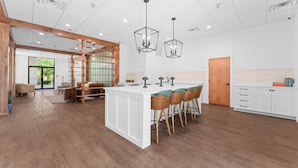 A spacious kitchen with a central island, bar stools, and pendant lighting. - Branson Falls Lodge (Branson)