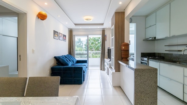 Un appartement moderne comprenant un espace de vie, une cuisine et un balcon.