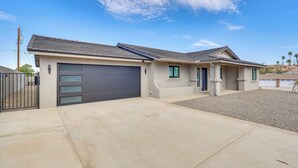 A two-story house with a garage, a driveway, and a gravel area. - 2 Mi to Windsor Beach! Updated, Sleek Family Home (Lake Havasu City)