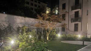 A well-maintained garden with a variety of plants and a bicycle parked nearby.