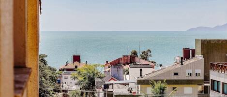 A coastal cityscape with buildings overlooking the sea.