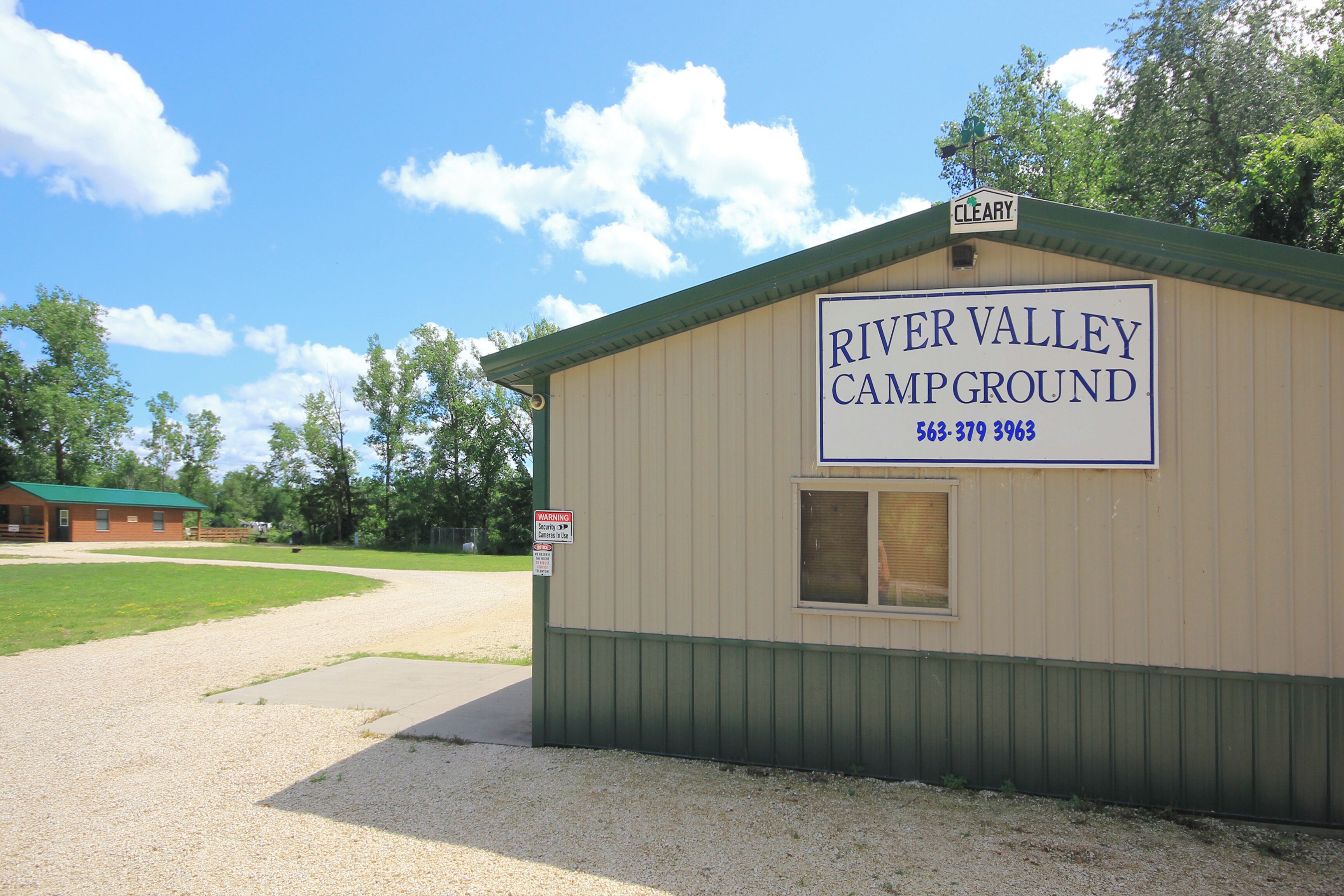 A small building labeled 'River Valley Campground' with a contact number.
