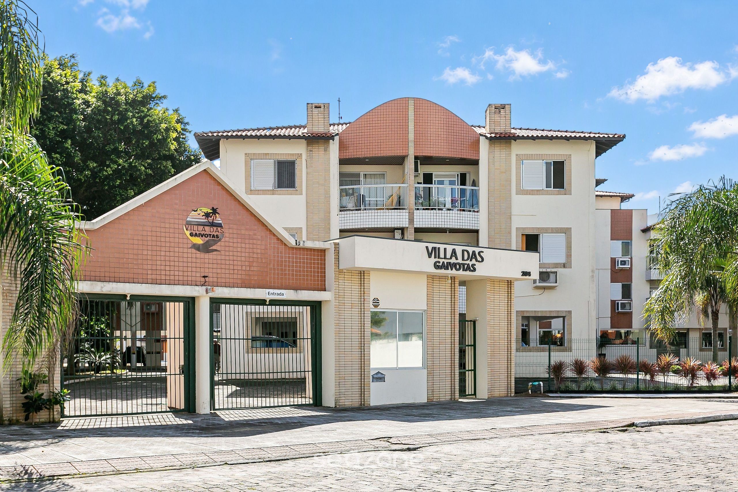 A multi-story building with a sign reading 'Villa das Gaivotas.'