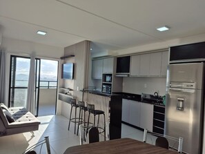Deluxe Apartment, Pool Access, Beach View | Private kitchen | Dining tables