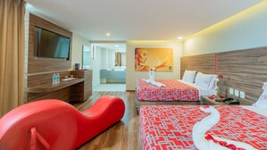 A hotel room with two beds, a red sofa, a TV, and a bathroom visible through an open door. - Hotel Ecatepec (Ecatepec de Morelos)