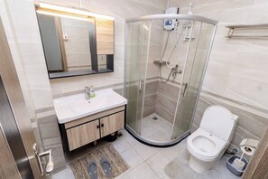 Shower, towels, soap, toilet paper