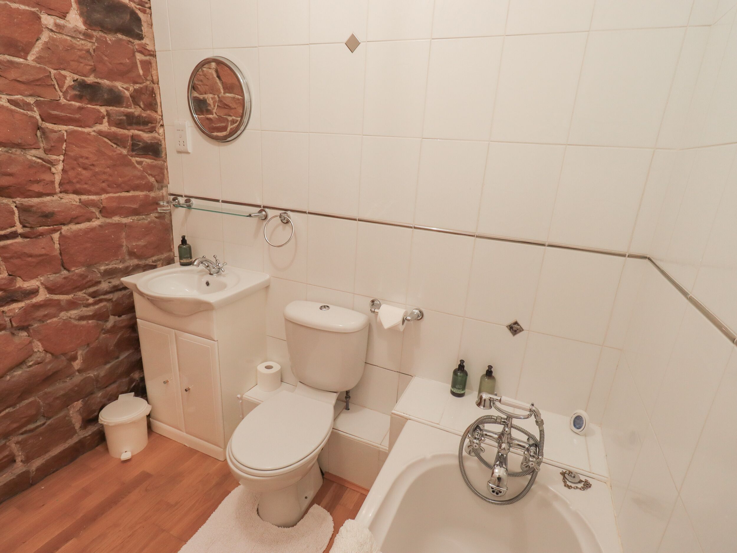 A bathroom with a toilet, sink, and bathtub.