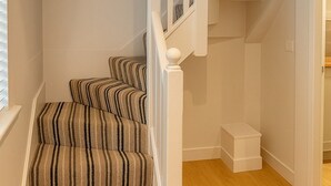 A staircase with striped carpet and white balusters. - Elegant 2Bd Townhouse In Thirsk: Cozy & Stylish (Thirsk)
