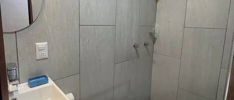 A bathroom with a sink, toilet, and shower.