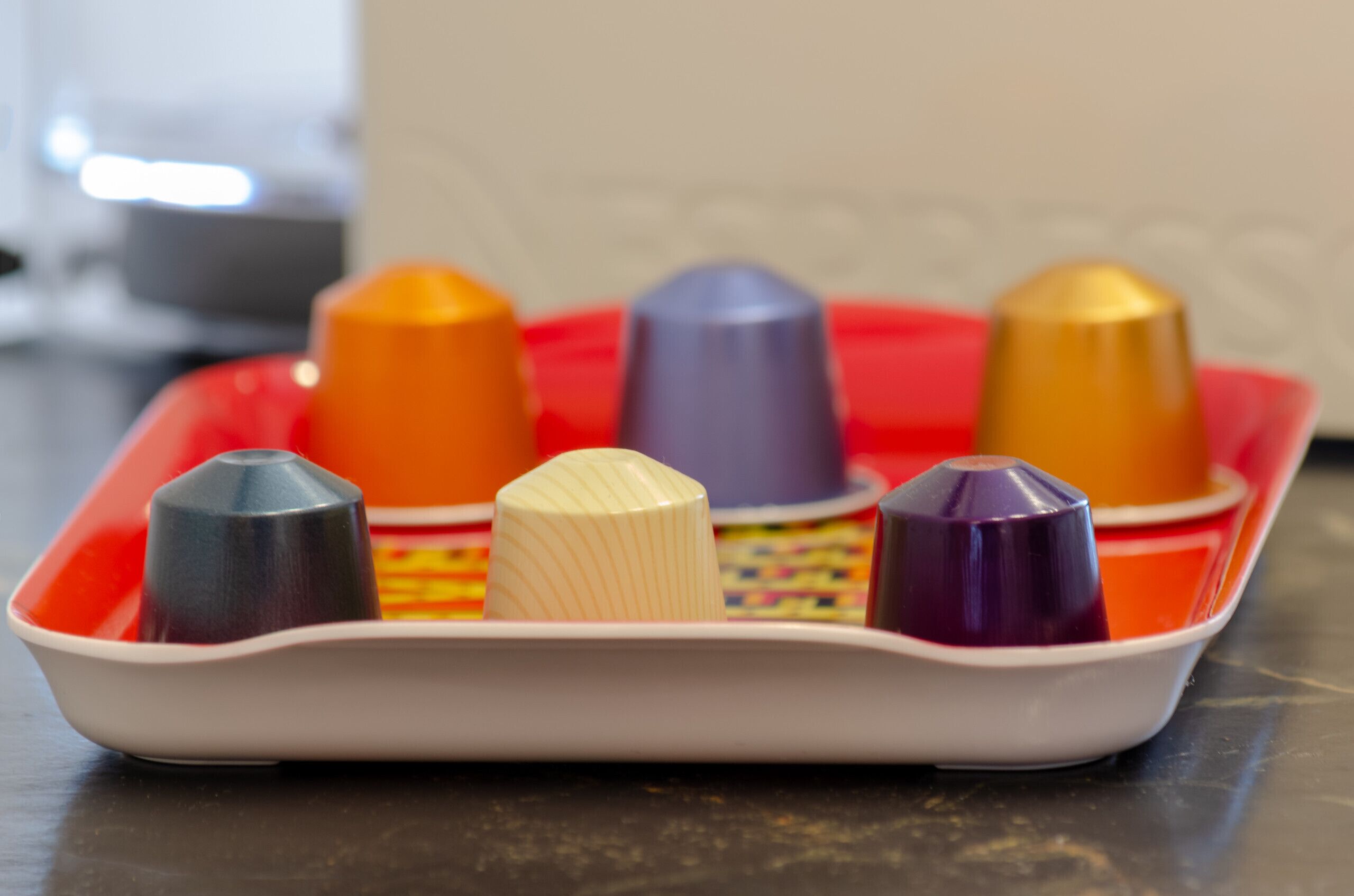 A tray with six colorful plastic molds.