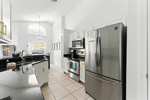Fridge, microwave, stovetop, dining tables