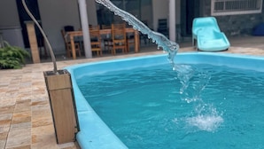 A swimming pool with a water feature.