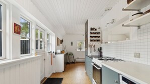 A kitchen with white cabinetry, a stove, and a dishwasher.