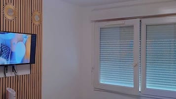 Tabla de planchar con plancha, internet y ropa de cama