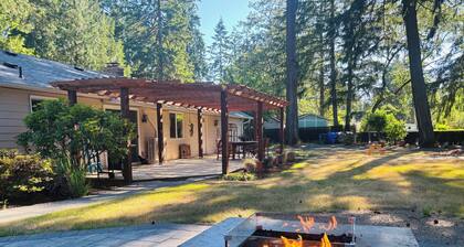 The PNW little Oasis features an abundance of firs, ferns and rhododendrons.