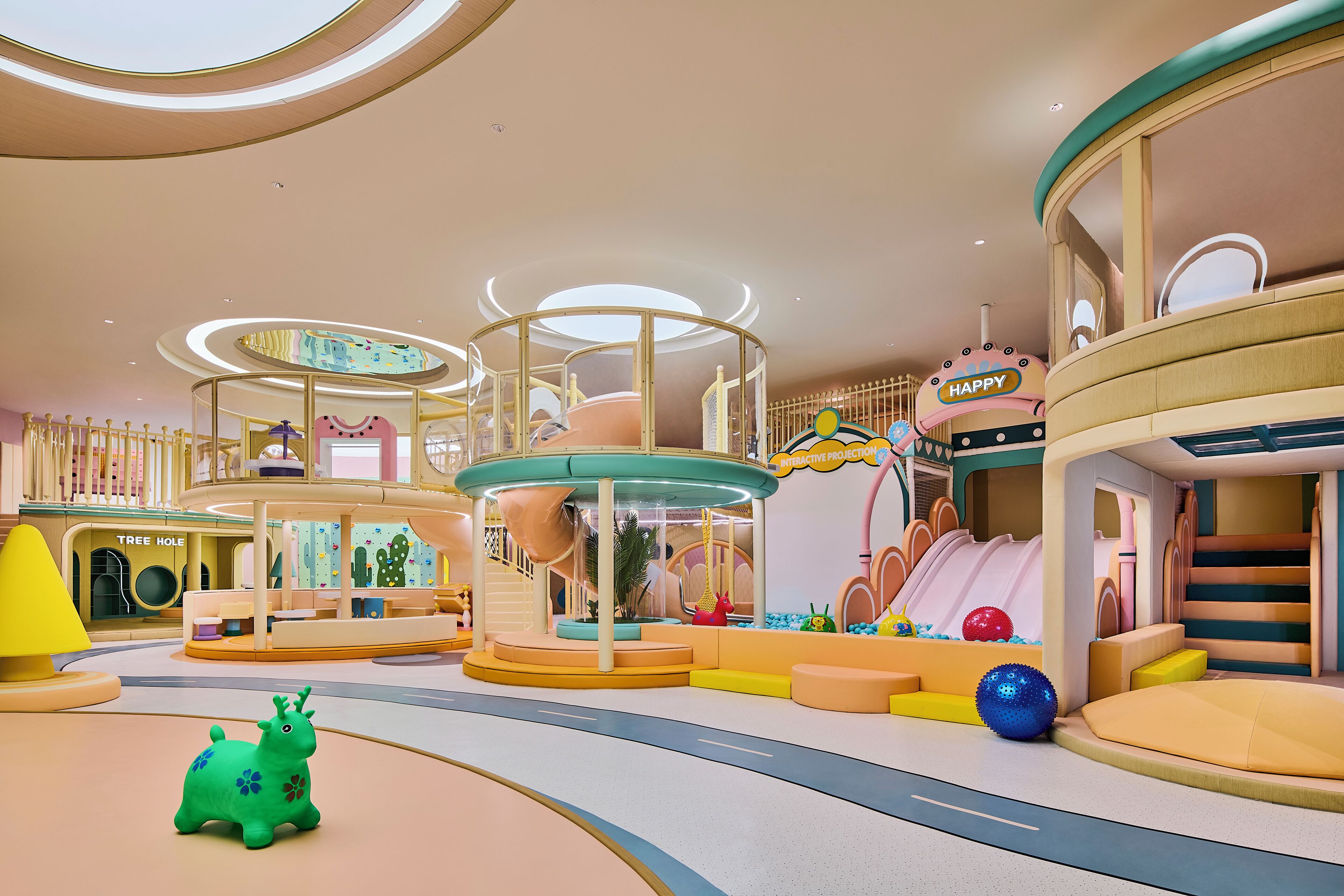 A children's play area with slides, climbing structures, and a ball pit.