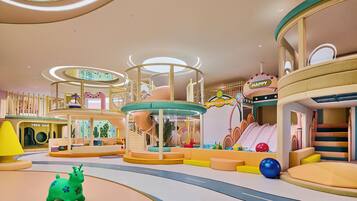 A children's play area with slides, climbing structures, and a ball pit.