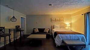 Una habitación de hotel con una cama, un escritorio y una silla.