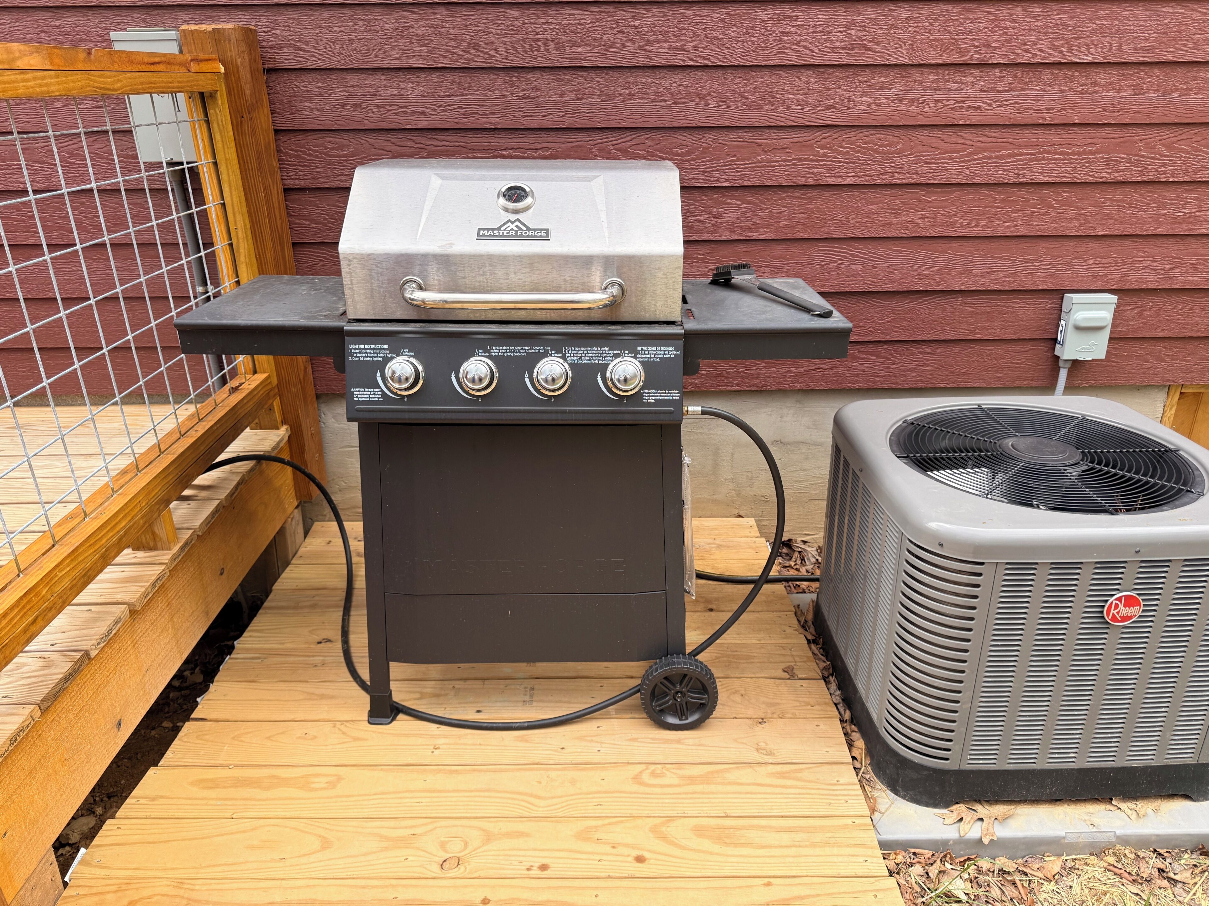 A portable grill with a control panel, a fan, and a wooden deck.