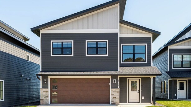 A modern two-story house with a garage, a front door, and a small porch. - RiverWest Kayak View -Hot Tub - Riverview-Dog Friendly (Duluth)