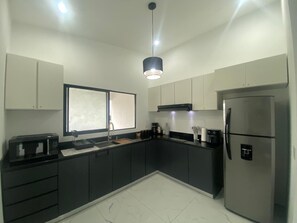 Fridge, microwave, stovetop, coffee/tea maker