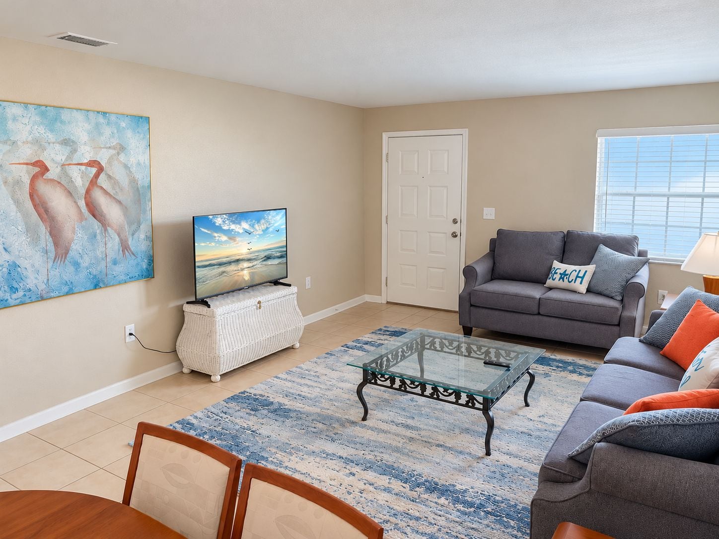 A living room with a television, sofa, and coffee table.