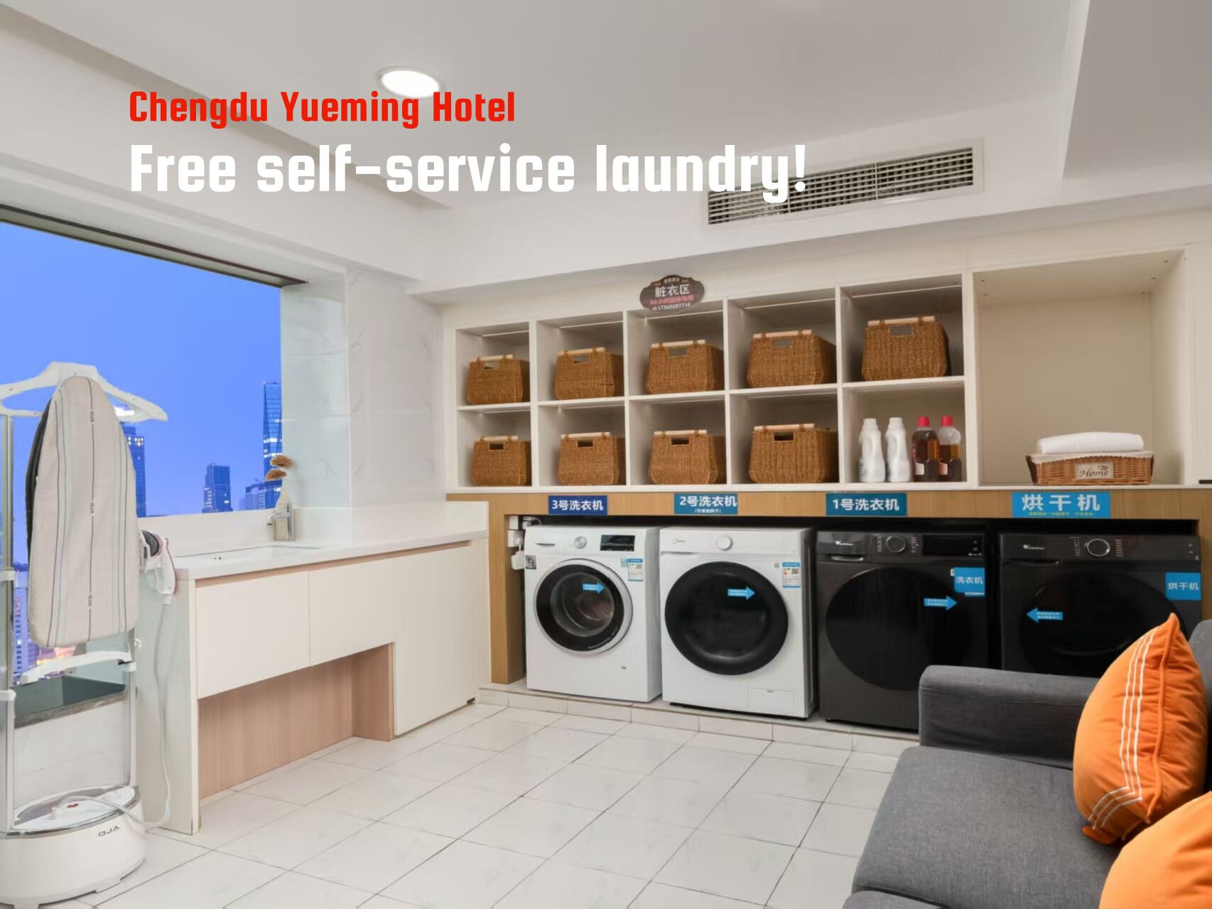 A hotel room with a self-service laundry area, including multiple washing machines and drying machines.