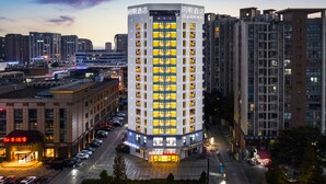 A high-rise hotel with multiple floors, large windows, and a well-lit entrance. - Chengdu Yueming Hotel (Chengdu)