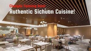 A Chengdu Yueming Hotel dining area with modern decor, multiple seating arrangements, and a patterned floor. - Chengdu Yueming Hotel (Chengdu)