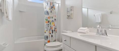 Un baño moderno con bañera, inodoro y lavamanos.
